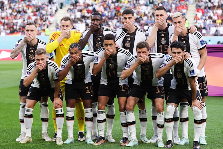 German team players cover their mouths with their hands
