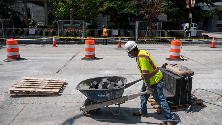 Construction workers repairs a street near the White House, in Washington, DC. 