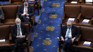 A masked Mitch McConnell sits across the aisle from a masked Chuck Schumer in a nearly empty Senate.
