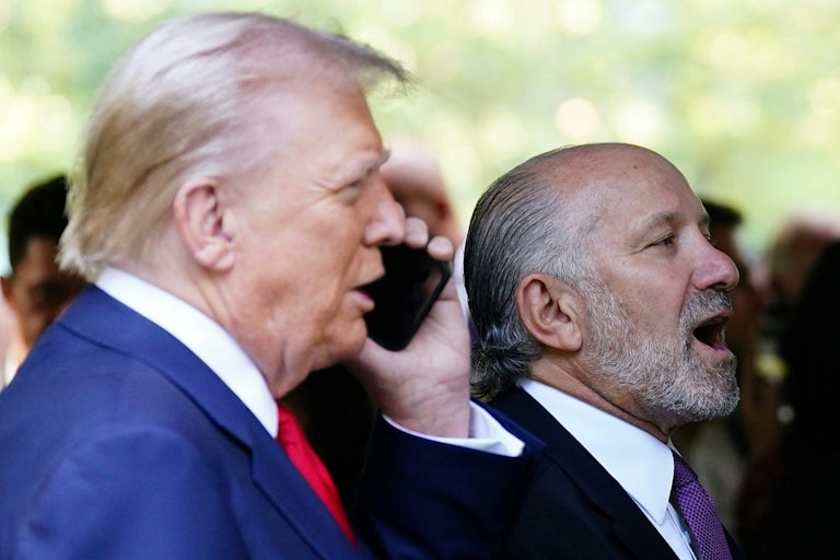 Donald Trump and Howard Lutnick are seen in profile as they stand next to each other