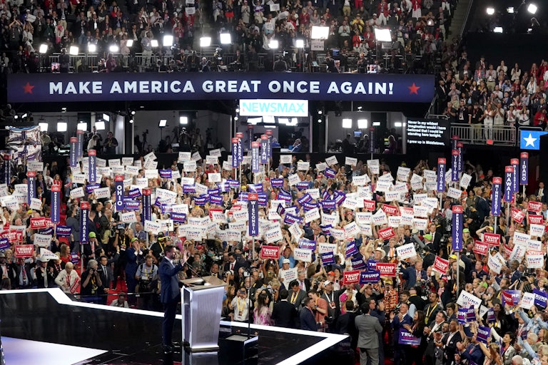 J.D. Vance speaks as the crowd at the Republican National Convention waves pro-Trump signs