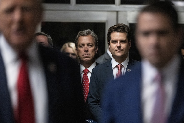Andy Ogles stands next to Matt Gaetz as Donald Trump and Todd Blanche speak