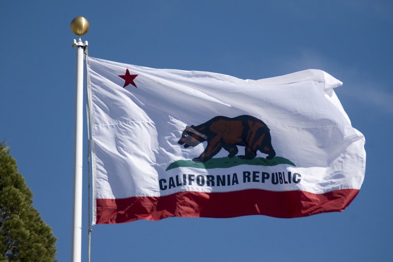 California state flag blowing in the wind on a pole