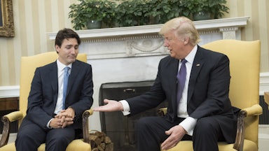 Justin Trudeau looks skeptically at Donald Trump, who is offering him his hand.