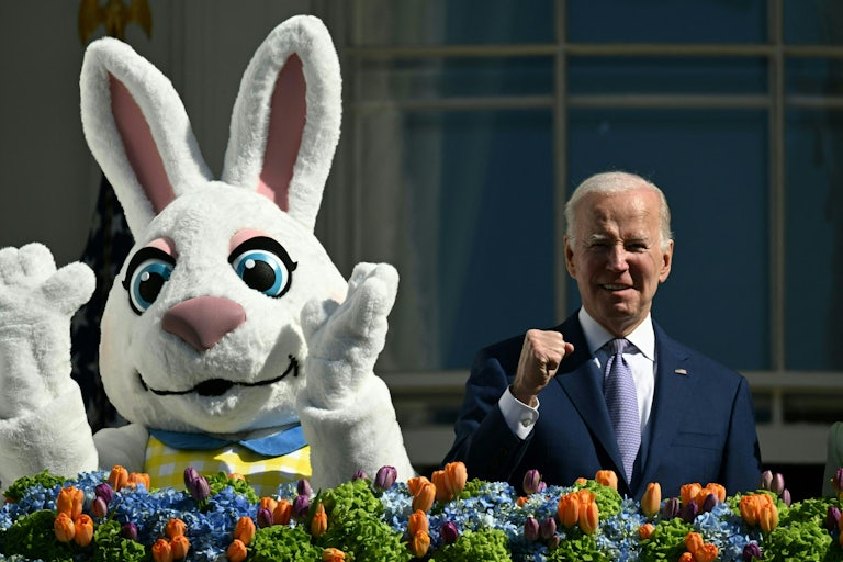 Joe Biden fist pumps while standing next to an Easter bunny