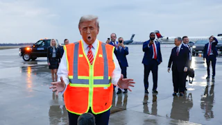 Donald Trump gestures while speaking to reporters