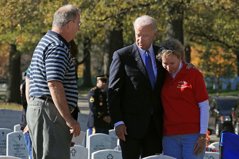 Joe Biden stands with David Smith’s parents in Arlington Cemetery.