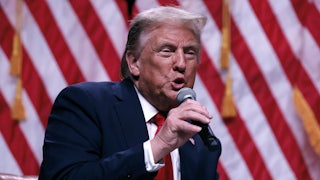 Donald Trump speaks into a handheld microphone