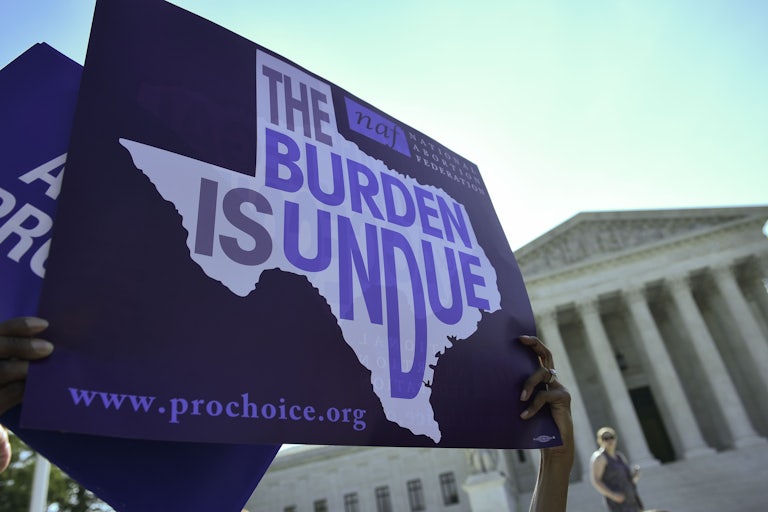 Pro-choice protestors bring signs to the steps of the Supreme Court.