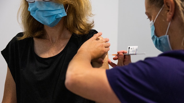 A nurse administers the AstraZeneca Covid-19 vaccine to a patient.