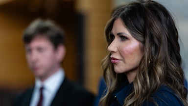 Homeland Security Secretary Kristi Noem stands in profile to the camera