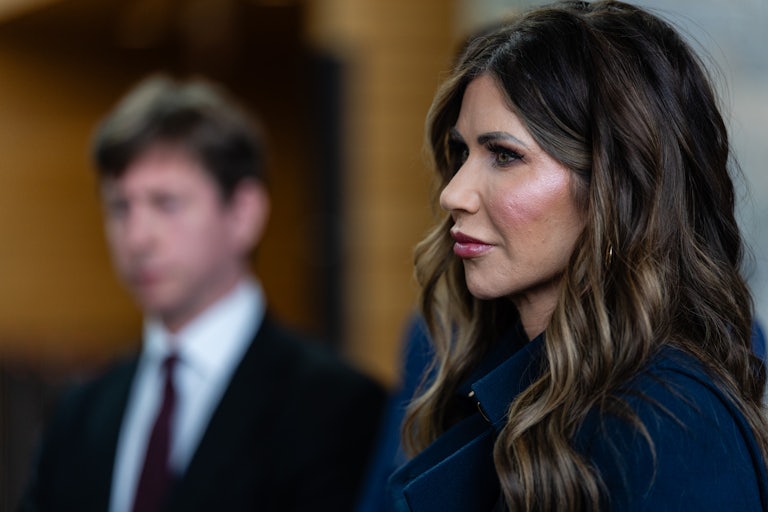 Homeland Security Secretary Kristi Noem stands in profile to the camera