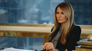 First lady Melania Trump seated in front of a window