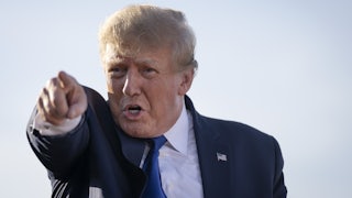 A close-up of President Donald Trump, pointing in the distance.