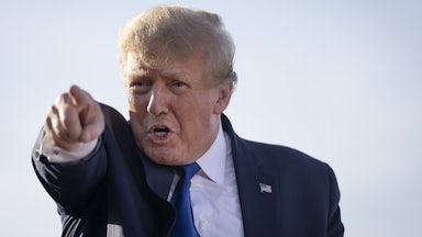 A close-up of President Donald Trump, pointing in the distance.