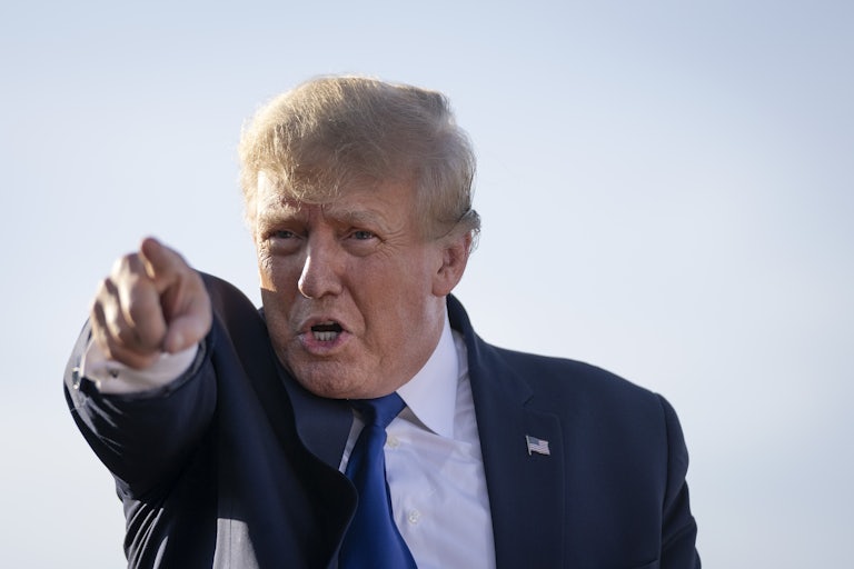 A close-up of President Donald Trump, pointing in the distance.
