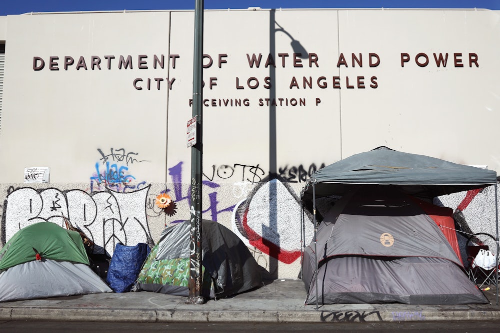 A homeless encampment stands in front of a city water and power building in the Skid Row community in Los Angeles, California.