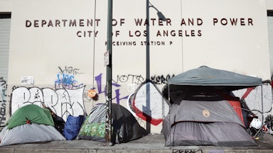 A homeless encampment stands in front of a city water and power building in the Skid Row community in Los Angeles, California.