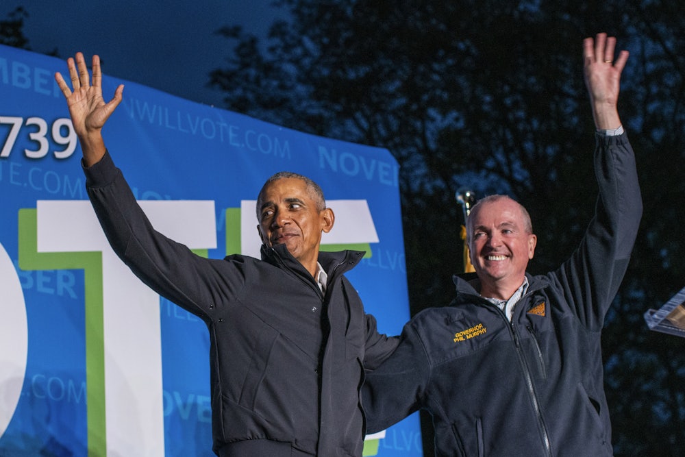 Former U.S. President Barack Obama and New Jersey Governor Phil Governor Murphy wave at attendees after taking part in an early vote rally in Newark, New Jersey.