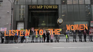People hold up letters that spell out "Listen to the women" during a protest outside Trump Tower in New York City
