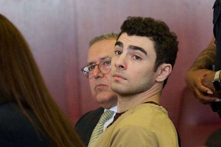 Luigi Mangione sits in a courtroom