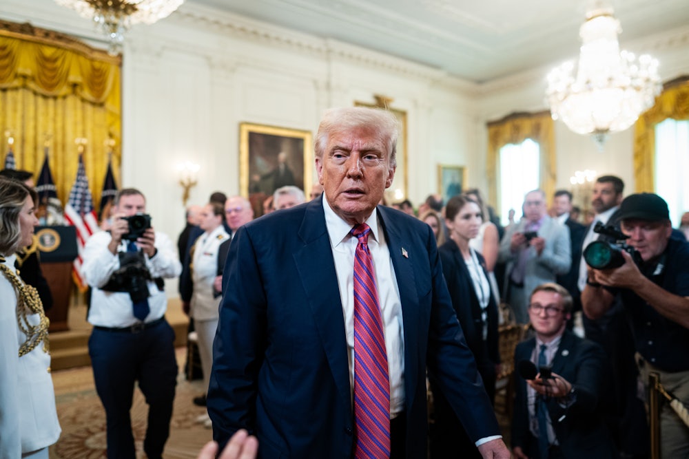 Donald Trump departs following a signing ceremony for the GENIUS Act in the East Room of the White House.