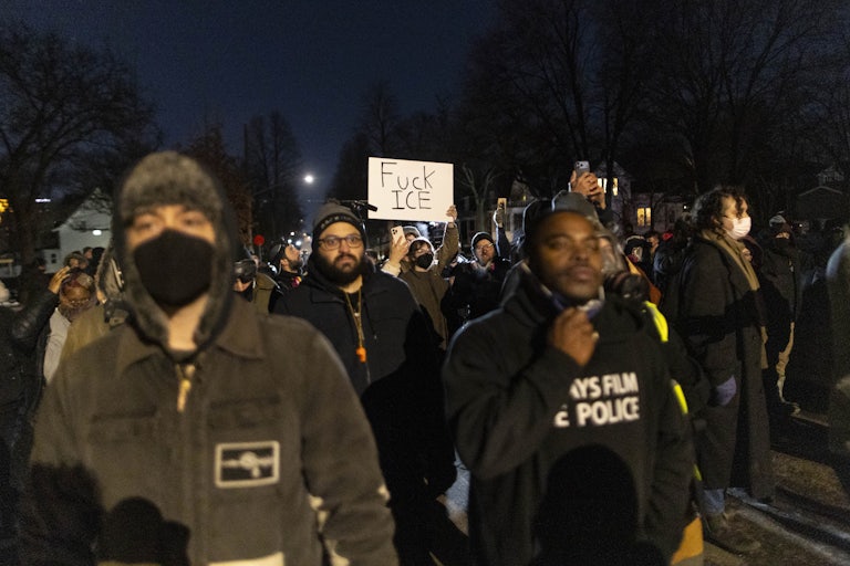 A person holds up a sign that says, "Fuck ICE" during an anti-ICE protest in Minneapolis, Minnesota.