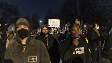 A person holds up a sign that says, "Fuck ICE" during an anti-ICE protest in Minneapolis, Minnesota