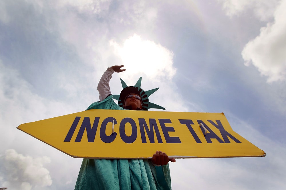 A man holds a sign advertising a tax preparation office for people that still need help completing their taxes before the Internal Revenue Service deadline on April 14, 2010 in Miami, Florida.