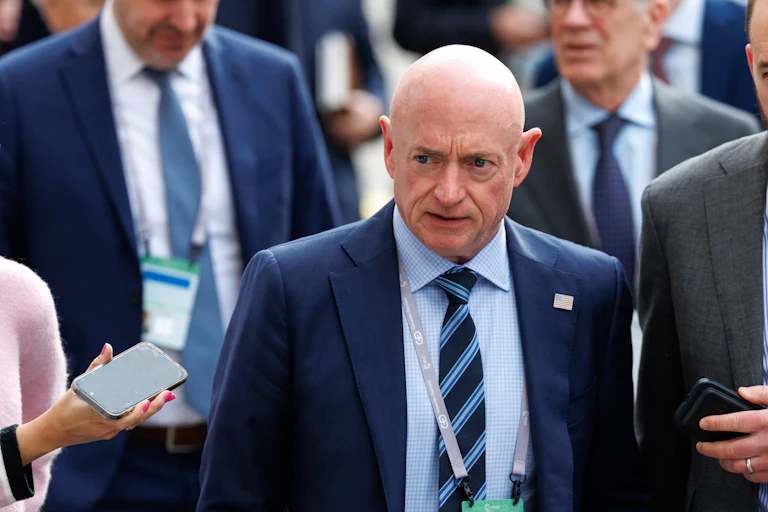 Senator Mark Kelly walks at the Munich Security Conference