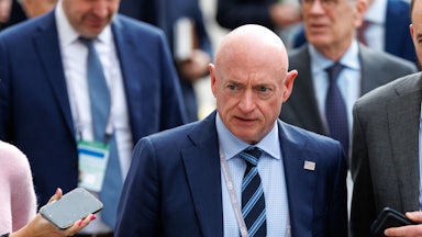 Senator Mark Kelly walks at the Munich Security Conference