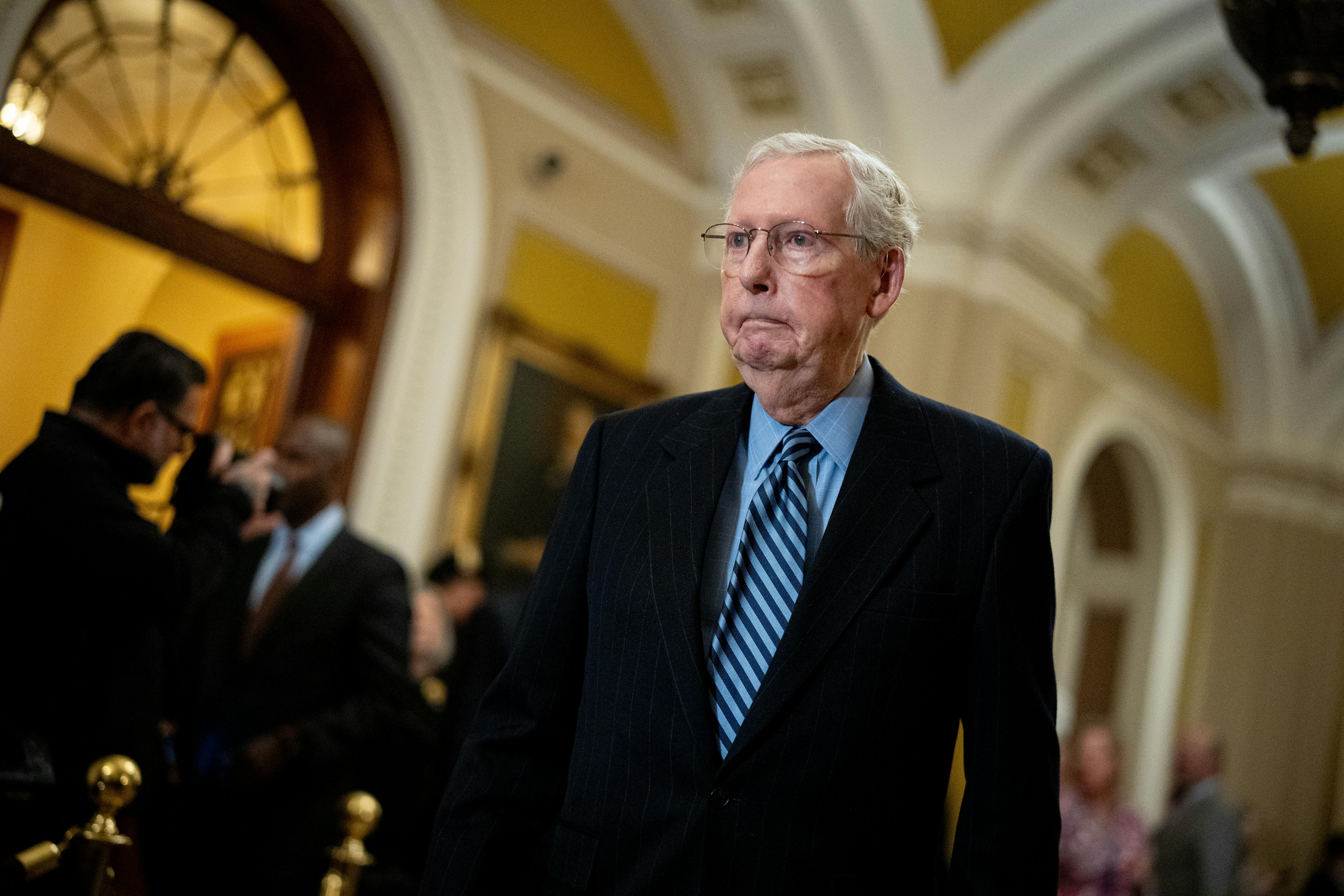 Mitch McConnell walks in the Capitol.
