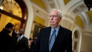 Mitch McConnell walks in the Capitol.