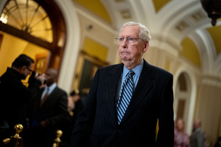 Mitch McConnell walks in the Capitol.