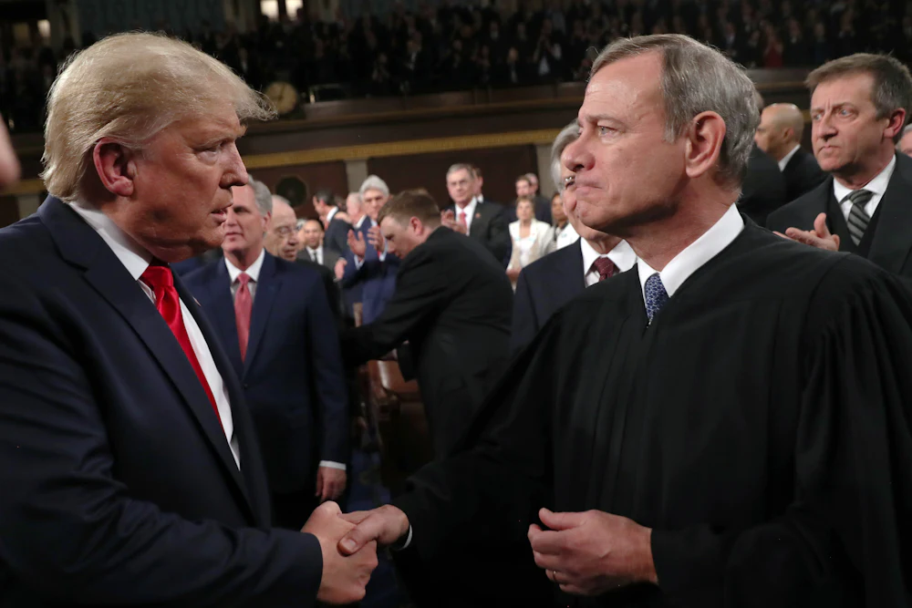 Donald Trump shakes hands with Supreme Court Chief Justice John Roberts.