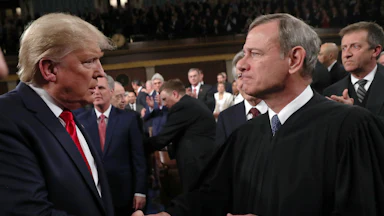 Donald Trump shakes hands with Supreme Court Chief Justice John Roberts.