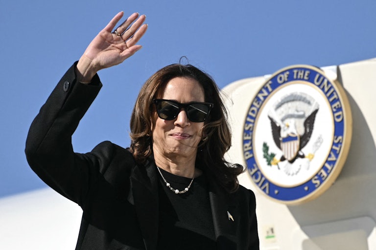 Kamala Harris waves while boarding Air Force Two