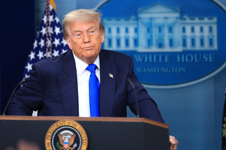 Donald Trump stands behind the podium in the White House press briefing room.