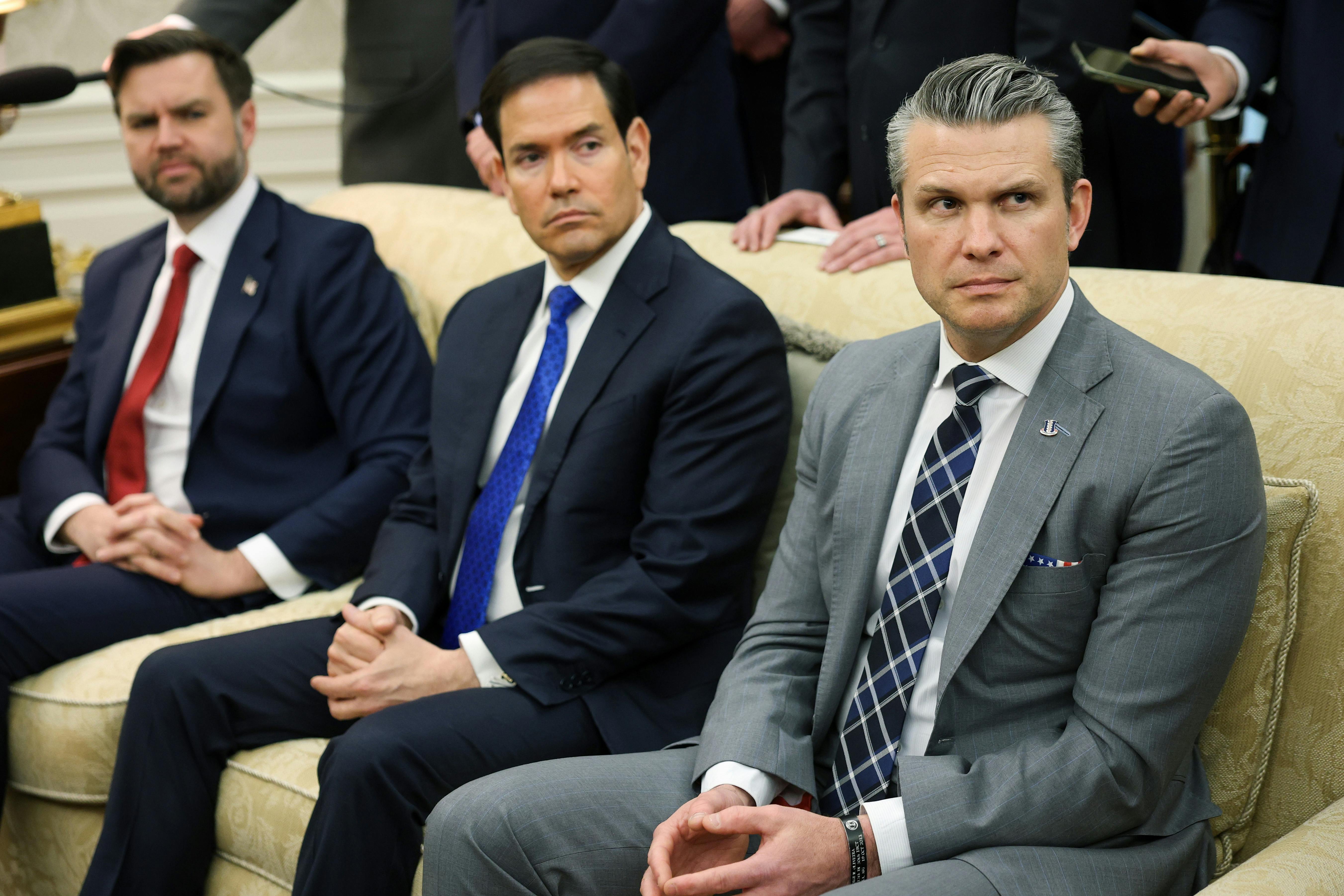 Vice President JD Vance, Secretary of State Marco Rubio, and Defense Secretary Pete Hegseth sit next to each other on a couch in the Oval Office