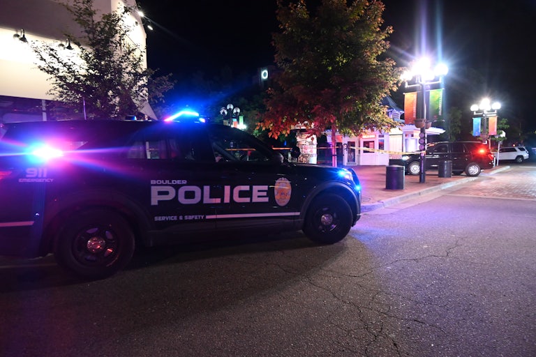 Police cars are parked near the scene of an attack in Boulder, Colorado