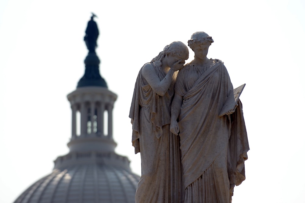 Statues depicting Grief and History stand watch over the U.S. Capitol.
