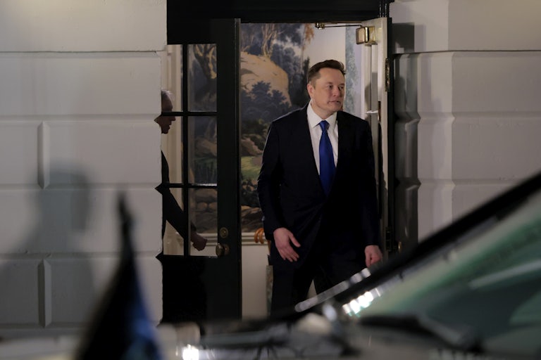Elon Musk exits a building