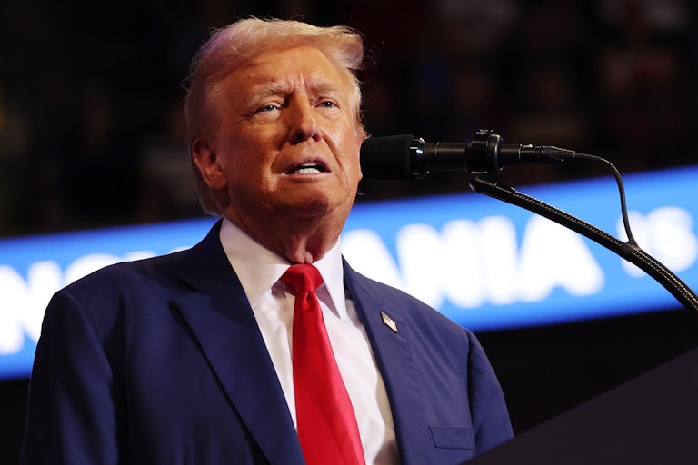 Donald Trump makes a weird face while speaking before a mic