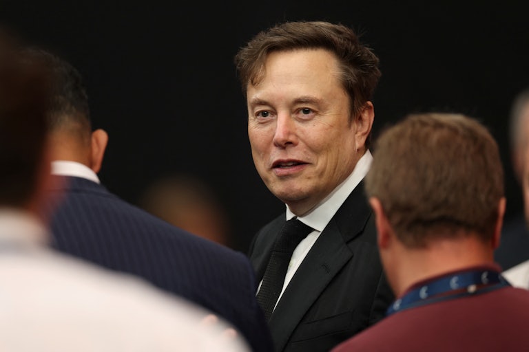 Elon Musk stands in a crowd during Charlie Kirk's memorial service