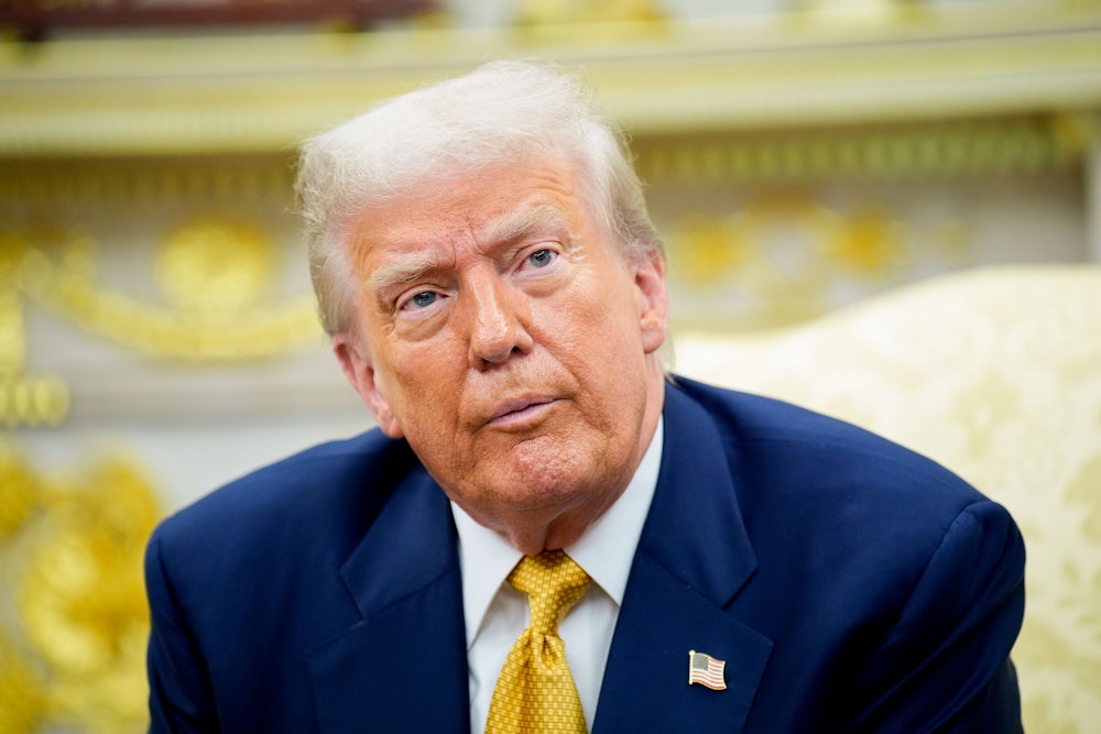 Donald Trump sits in the Oval Office and stares ahead with bloodshot eyes