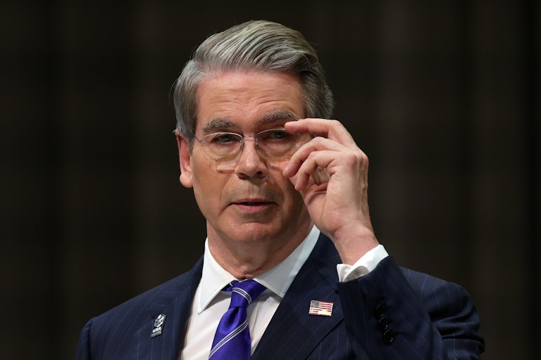 Treasury Secretary Scott Bessent adjusts his glasses.