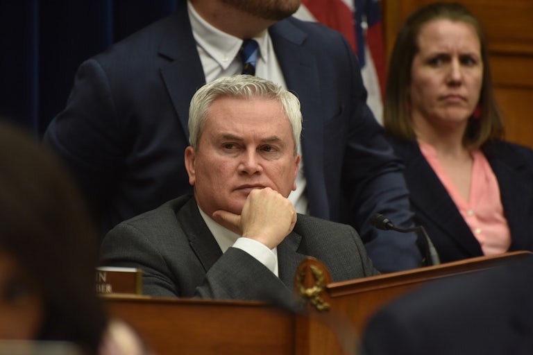 James Comer holds his chin in his hand