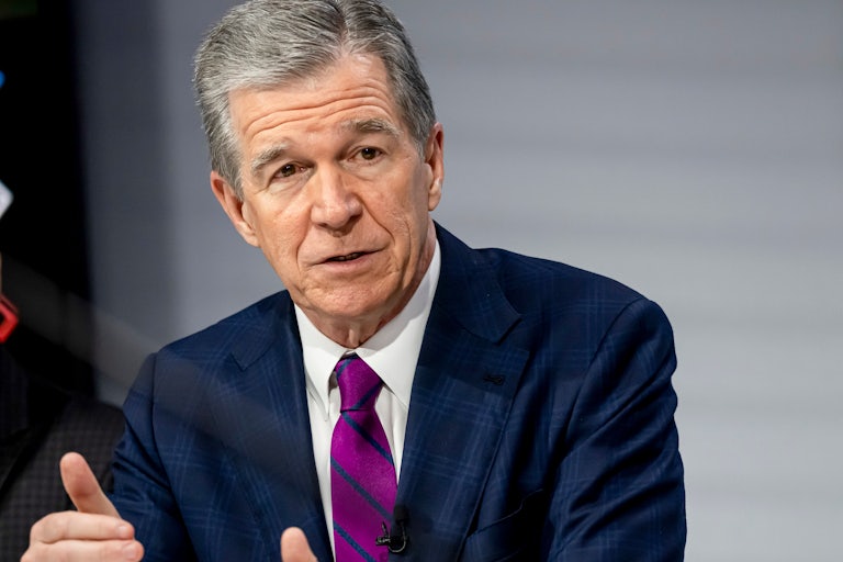 North Caorlina Governor Roy Cooper speaks and makes hand gestures