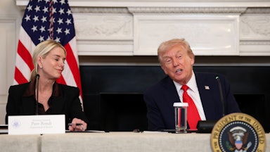 Donald Trump speaks while Attorney General Pam Bondi smiles at him while they sit at a table for the White House antifa discussion.