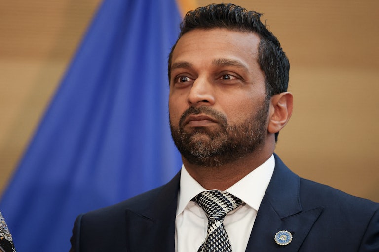 Kash Patel stands during a press conference